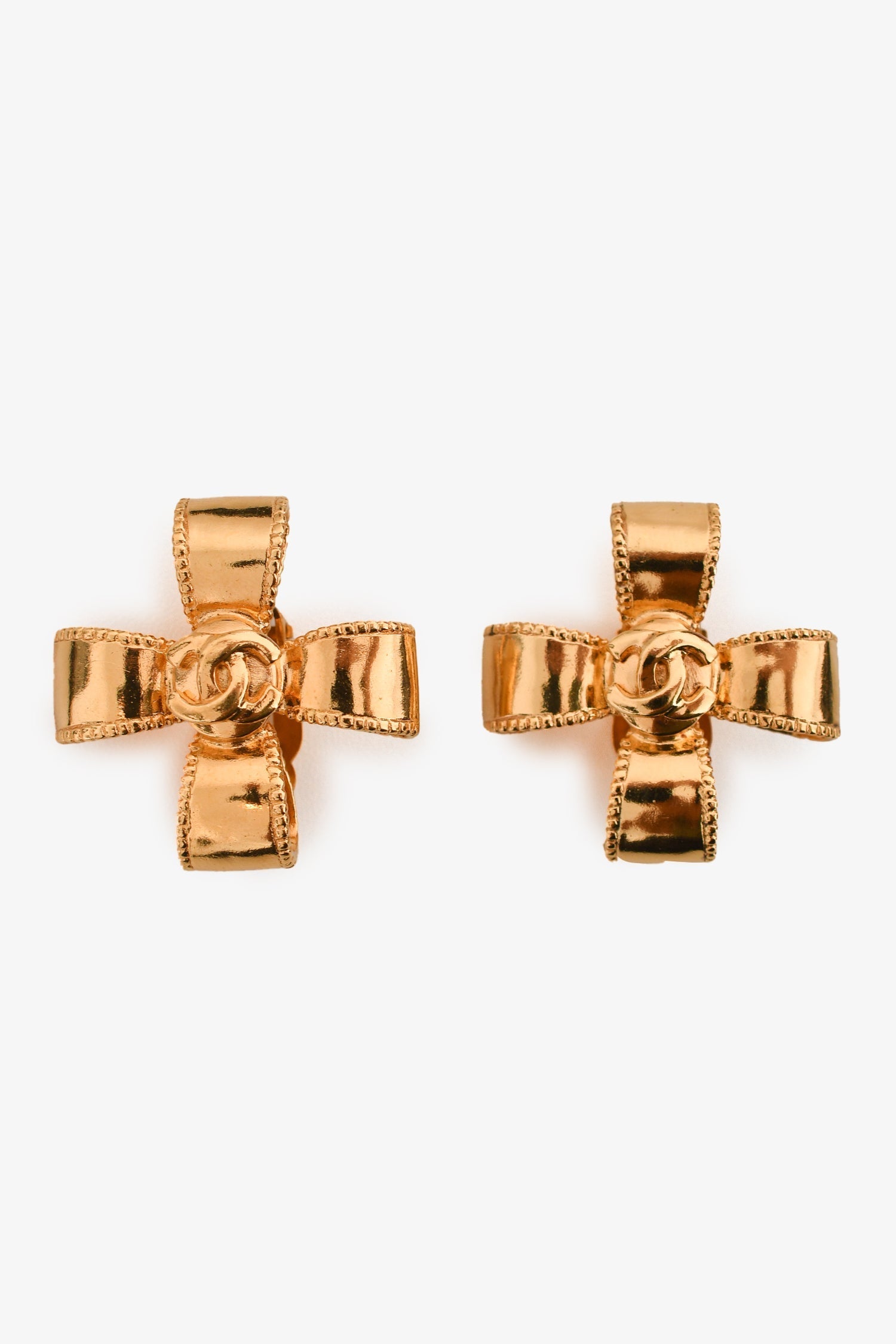 Chanel™ 97A Gold Tone Coco Mark Cross Ribbon Clip-on Earrings