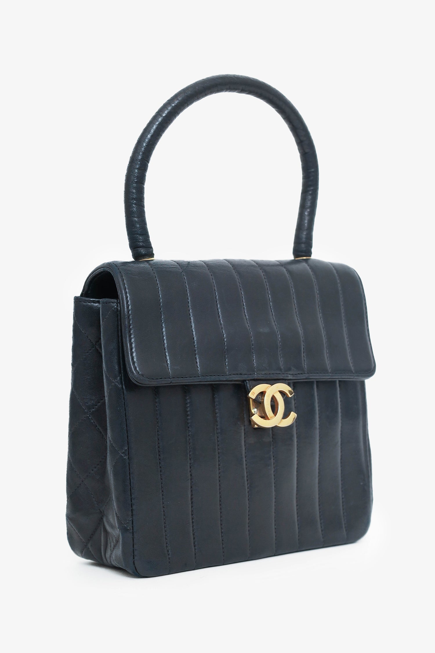 Chanel™ 1991-94 Black Vertical Quilted Lambskin Top Handle Bag